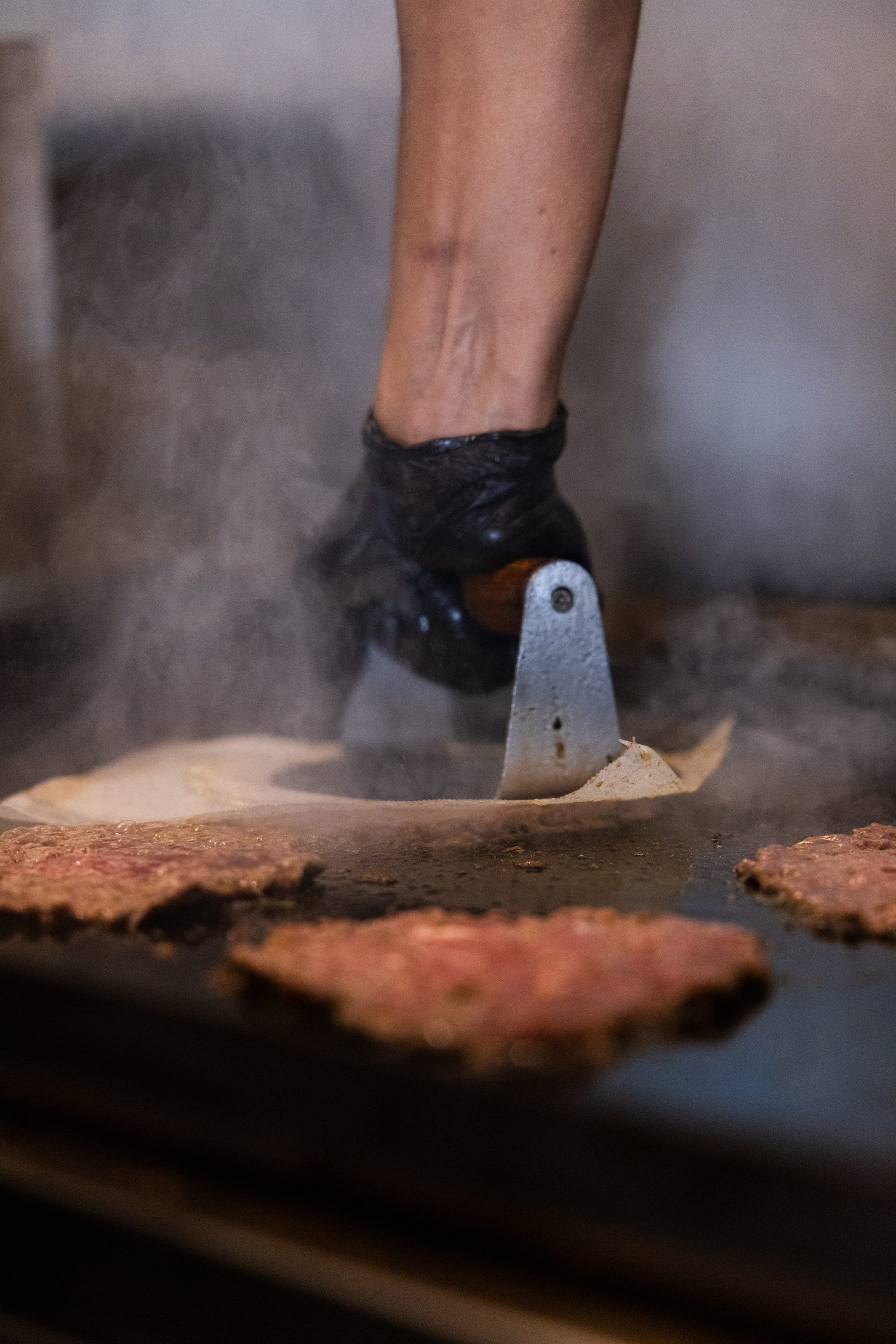 Smashing the patty with steam